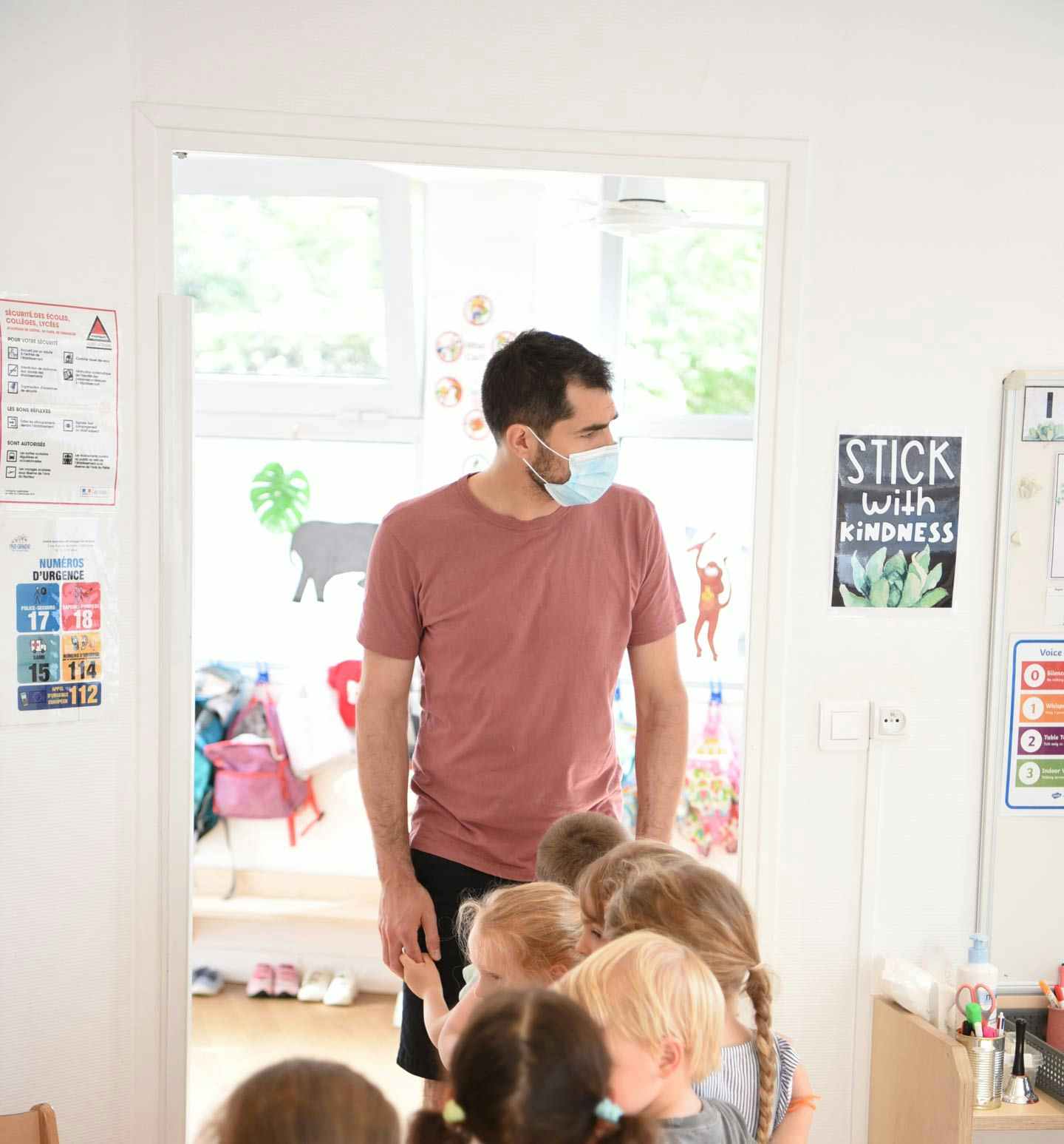 A preschool teacher with kids in a classroom