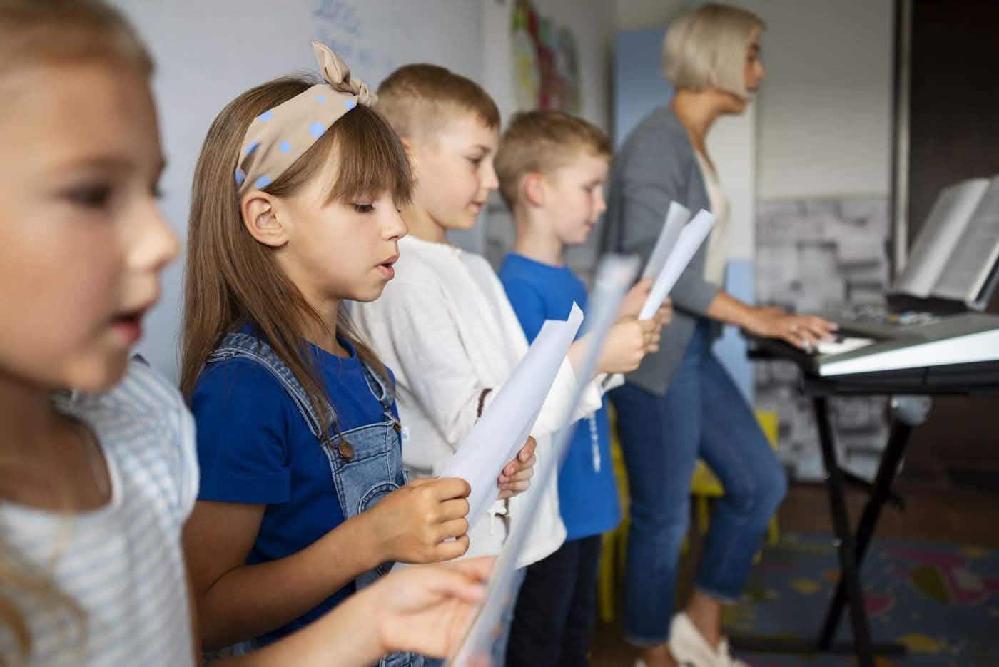 Children sing in a choir while reading their score